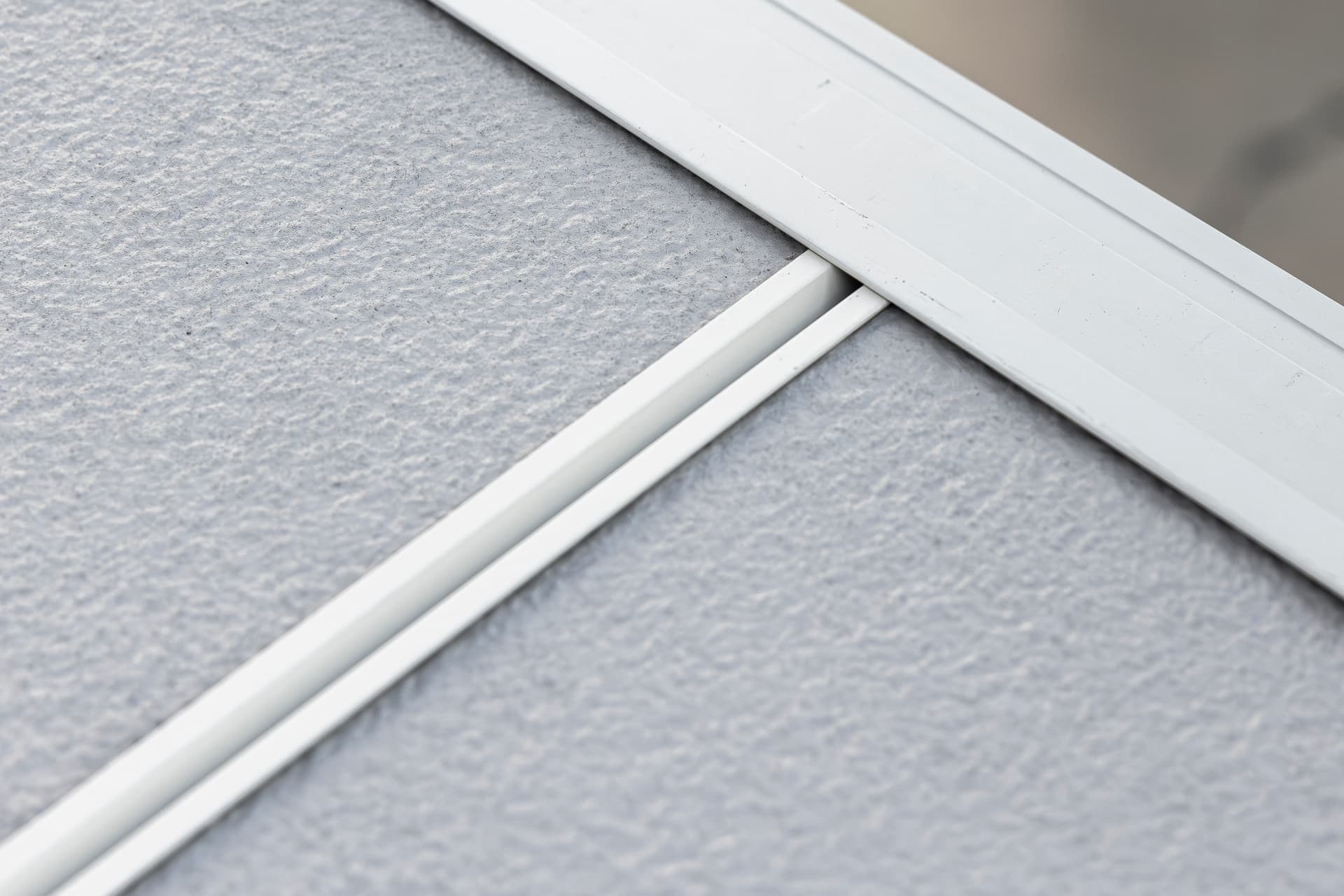 Manufacturer-supplied close-up of James Hardie panel and trim installation detailing